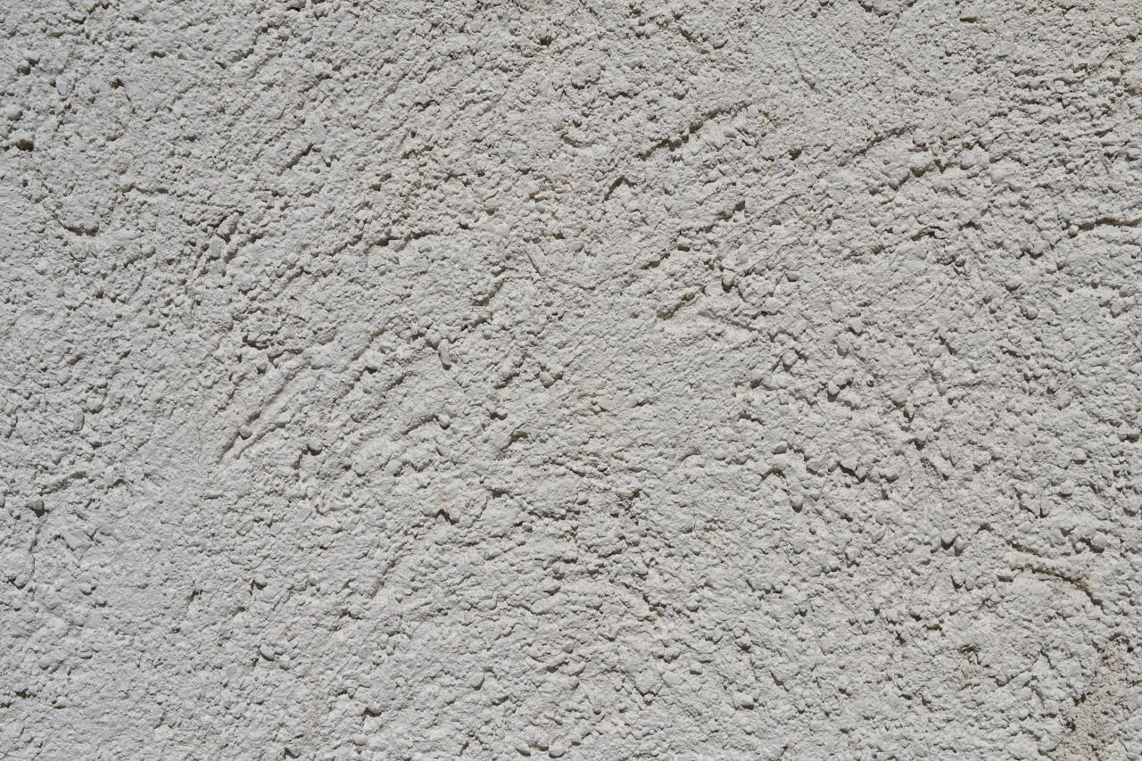 About Close-up of a light gray stucco wall texture, ideal for backgrounds.