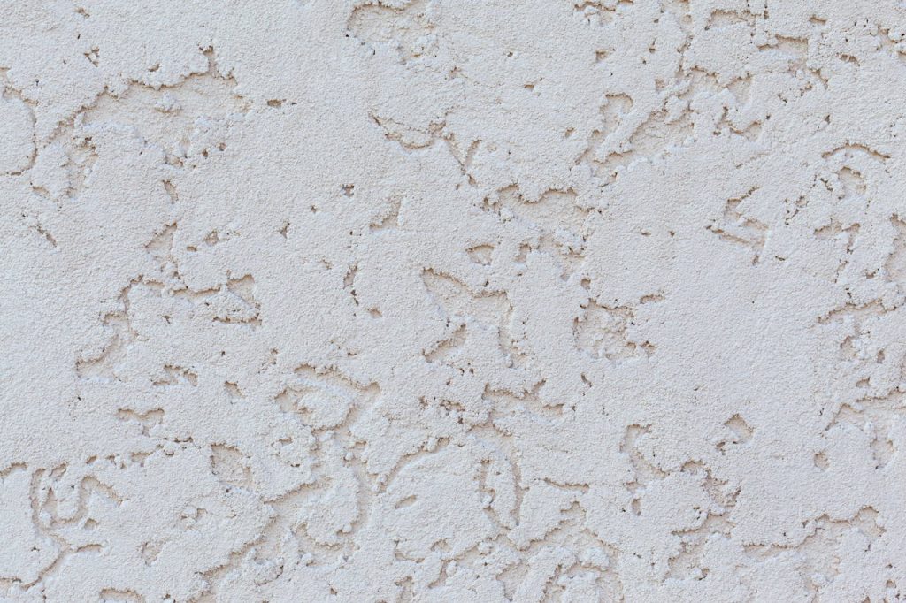 texture-of-white-wall-with-decorative-stucco-4913793 Detailed close-up of a textured white plaster wall surface, perfect for backgrounds or design elements.